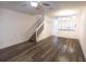 A bright and open living room with hardwood floors, stairs, and a bar area to the kitchen at 8545 Hunters Key Cir, Tampa, FL 33647