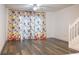 A brightly lit living room with sleek hardwood floors, ceiling fan and an adjacent staircase at 8545 Hunters Key Cir, Tampa, FL 33647