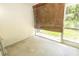 Enclosed patio with an AC unit and a bamboo shade, leading to an outdoor view at 8545 Hunters Key Cir, Tampa, FL 33647