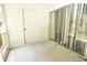 Enclosed patio with sliding glass doors and a door leading outdoors, featuring concrete floors at 8545 Hunters Key Cir, Tampa, FL 33647