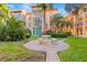 The property boasts a serene courtyard with a brick patio, an outdoor dining set, and lush tropical landscaping at 8921 Blind Pass Rd # 142, St Pete Beach, FL 33706