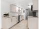 Updated kitchen features modern appliances, sleek cabinets, and a view of the bathroom at 8921 Blind Pass Rd # 142, St Pete Beach, FL 33706