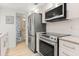 Kitchen showcasing stainless steel appliances, sleek cabinets, and granite countertops at 8921 Blind Pass Rd # 142, St Pete Beach, FL 33706