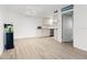 Bright living room showcases a modern kitchen with stainless appliances and light wood flooring at 8921 Blind Pass Rd # 142, St Pete Beach, FL 33706