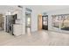 Open-concept living area with updated flooring, modern stainless appliances, and natural light at 8921 Blind Pass Rd # 142, St Pete Beach, FL 33706
