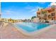 Community pool with lounge chairs and lush landscaping provides a relaxing outdoor space at 8921 Blind Pass Rd # 142, St Pete Beach, FL 33706
