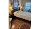 Comfortable bedroom with a view from the window, showcasing a queen-sized bed and hardwood floors at 9302 Trowbridge Ct, New Port Richey, FL 34655