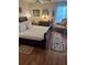 Serene bedroom showcases a queen-size bed, hardwood floors, and decorative accents at 9302 Trowbridge Ct, New Port Richey, FL 34655