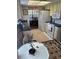 Efficient kitchen with appliances, opening up to the dining area with chandelier at 9302 Trowbridge Ct, New Port Richey, FL 34655