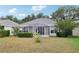 Lovely backyard with a screened in patio and green landscaping at 9329 Huntington Park Way, Tampa, FL 33647