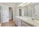 Spacious bathroom featuring double sinks, tile flooring, large mirrors, and a separate shower at 9329 Huntington Park Way, Tampa, FL 33647