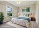 Inviting bedroom with large window, neutral colors, and plush carpet, virtually staged with stylish decor at 9329 Huntington Park Way, Tampa, FL 33647