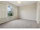 Inviting bedroom with large window, neutral colors, and plush carpet at 9329 Huntington Park Way, Tampa, FL 33647