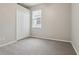 Bedroom with neutral colors, carpet, and a bright window at 9329 Huntington Park Way, Tampa, FL 33647