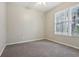 Bedroom with neutral colors, carpet, and a bright window view at 9329 Huntington Park Way, Tampa, FL 33647
