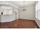 Bright dining room showcasing wood floors, natural light and modern chandelier at 9329 Huntington Park Way, Tampa, FL 33647