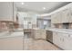 Kitchen features stainless steel dishwasher, ample counter space, and tile flooring at 9329 Huntington Park Way, Tampa, FL 33647