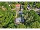 Aerial view showcasing the property surrounded by lush greenery and nearby houses at 9690 Jerome Dr, New Port Richey, FL 34654