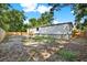 Spacious backyard features a wood fence, wood stairs and a home with gray siding at 9690 Jerome Dr, New Port Richey, FL 34654