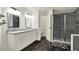 Beautiful bathroom features double sinks with a gray marble countertop and a glass door shower at 9690 Jerome Dr, New Port Richey, FL 34654