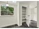 View of a room featuring a bright closet space with built-in shelving for organization at 9690 Jerome Dr, New Port Richey, FL 34654