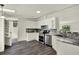 Kitchen with white cabinets, granite countertops, and stainless steel appliances at 9690 Jerome Dr, New Port Richey, FL 34654