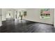 Bright living room featuring dark wood-look floors, white walls, and plenty of natural light at 9690 Jerome Dr, New Port Richey, FL 34654
