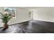 Bright living room with dark wood floors, and large windows offering natural light at 9690 Jerome Dr, New Port Richey, FL 34654