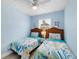 Charming bedroom with two twin beds, coastal-themed decor, and ample natural light at 9760 Little Gasparilla Island, Placida, FL 33946