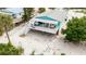 Beautifully elevated beach home with a covered porch and white railings at 9760 Little Gasparilla Island, Placida, FL 33946