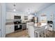 Bright kitchen with modern appliances, granite countertops, and bar seating at 9760 Little Gasparilla Island, Placida, FL 33946