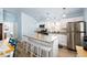 Open kitchen features white cabinets, granite countertops, and a central island with bar seating at 9760 Little Gasparilla Island, Placida, FL 33946
