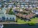Aerial view of waterfront condo community featuring lush landscaping, community pool, and boat docks at 1028 Apollo Beach Blvd # 21, Apollo Beach, FL 33572