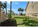 Picturesque waterfront backyard with lush lawn, mature landscaping, and beautiful water views beyond at 1028 Apollo Beach Blvd # 21, Apollo Beach, FL 33572