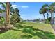 Picturesque backyard with views of the canal, swaying palms, and lush greenery, perfect for relaxation at 1028 Apollo Beach Blvd # 21, Apollo Beach, FL 33572