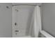 Bathroom with white tile shower and tub, featuring a shower curtain and updated fixtures at 1028 Apollo Beach Blvd # 21, Apollo Beach, FL 33572