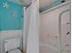 Bright bathroom features a tub with shower and grab bar and decorated with coastal-themed accents at 1028 Apollo Beach Blvd # 21, Apollo Beach, FL 33572