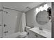 Full bathroom with tub and shower, toilet, white vanity, sink, and updated lighting at 1028 Apollo Beach Blvd # 21, Apollo Beach, FL 33572