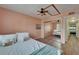Charming bedroom with a ceiling fan, view of the hallway, and large closet with mirror doors at 1028 Apollo Beach Blvd # 21, Apollo Beach, FL 33572