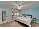 Bright bedroom with ceiling fan, closet, access to private balcony, and ensuite bathroom at 1028 Apollo Beach Blvd # 21, Apollo Beach, FL 33572