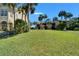 A well-maintained building exterior showcases lush green lawns, palm trees, and attractive landscaping at 1028 Apollo Beach Blvd # 21, Apollo Beach, FL 33572