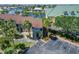 Waterfront condo exterior featuring lush tropical landscaping, assigned parking, and serene water views at 1028 Apollo Beach Blvd # 21, Apollo Beach, FL 33572