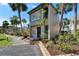 Charming two-story townhome featuring a quaint front garden with lush landscaping and a welcoming entryway at 1028 Apollo Beach Blvd # 21, Apollo Beach, FL 33572