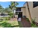 Exterior view of a home with a screened patio, landscaped yard, and tropical palm trees at 1028 Apollo Beach Blvd # 21, Apollo Beach, FL 33572