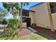 Exterior view of a home with a screened patio, landscaped yard, and tropical palm trees at 1028 Apollo Beach Blvd # 21, Apollo Beach, FL 33572