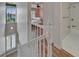 Upstairs hallway featuring view to bedroom with light pink walls and bathroom with white tile and updated fixtures at 1028 Apollo Beach Blvd # 21, Apollo Beach, FL 33572