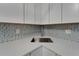 Kitchen sink with granite countertop and modern backsplash at 1028 Apollo Beach Blvd # 21, Apollo Beach, FL 33572