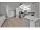 Modern kitchen with white cabinets, stainless steel appliances, and breakfast bar at 1028 Apollo Beach Blvd # 21, Apollo Beach, FL 33572