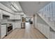Open kitchen and living area with modern appliances and staircase at 1028 Apollo Beach Blvd # 21, Apollo Beach, FL 33572