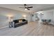 Bright and airy living room featuring modern decor, laminate flooring, and a ceiling fan at 1028 Apollo Beach Blvd # 21, Apollo Beach, FL 33572
